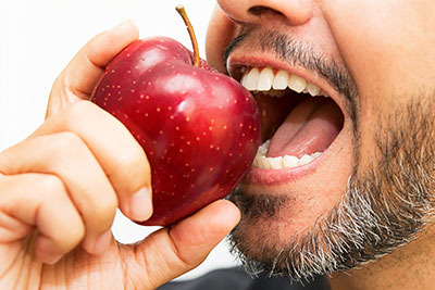 Close Up of Man Eating An Apple
