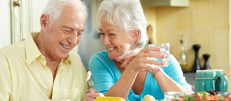 Smiling Elderly Couple discuss a root canal