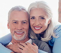 Smiling Elderly Couple with porcelain ceramic crowns